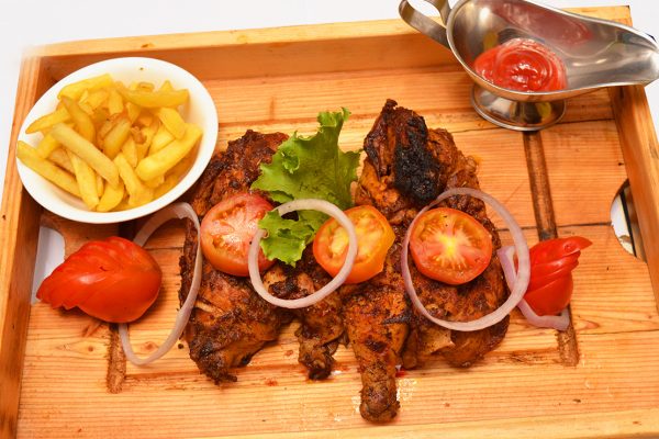 Platter of BBQ whole chicken with chips